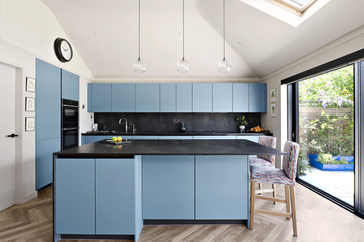 new-malden-spacious-kitchen-blue-units-glass-wall.jpg
